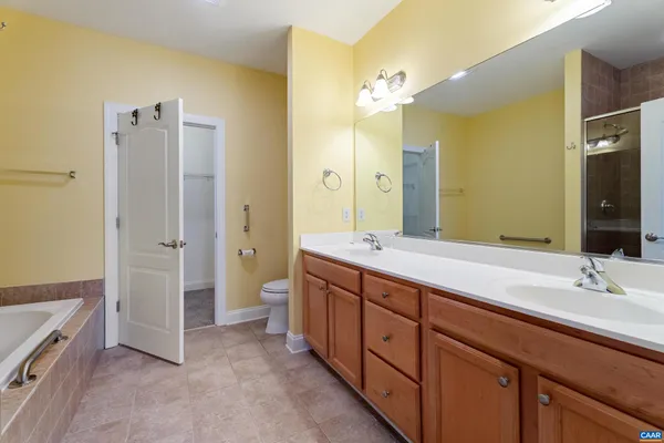 a spacious bathroom with a double vanity sink mirror double and shower