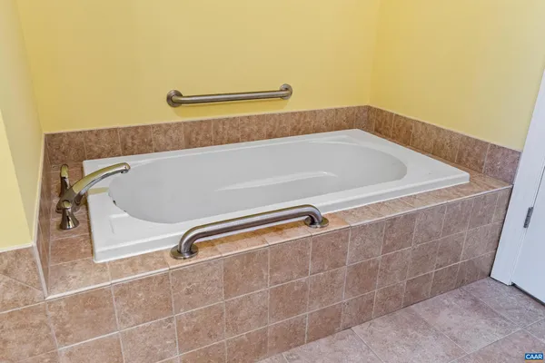 a bathroom with a bath tub and shower