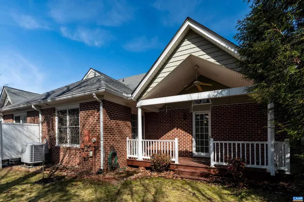 a view of house with backyard and porch