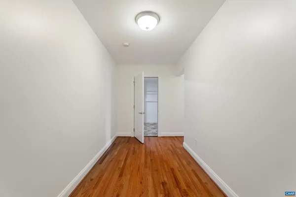 a view of a room with wooden floor and window