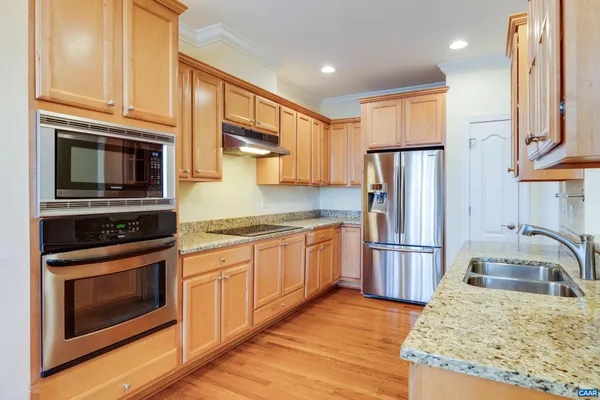 a kitchen with refrigerator cabinets and stainless steel appliances