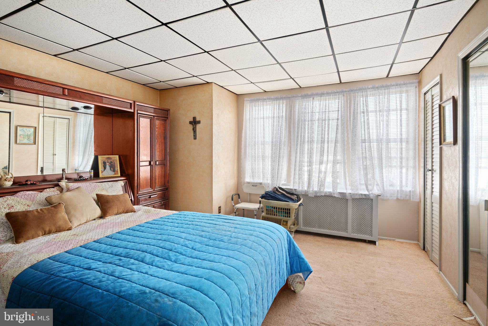 7818 Lennox Road Upper Darby, PA 19082 - Photo 14 of 28 a bedroom with a bed and a dresser next to a window