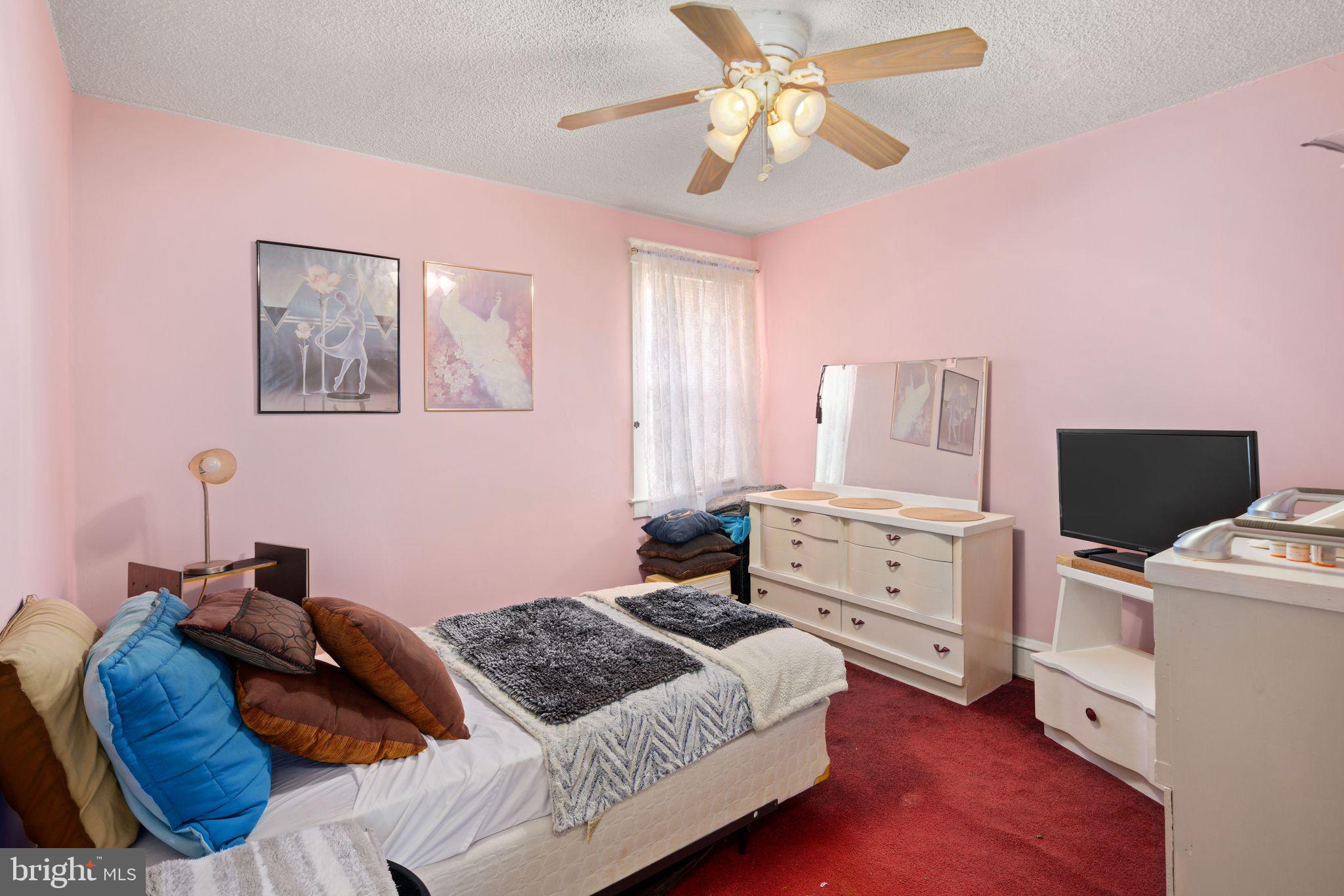 7818 Lennox Road Upper Darby, PA 19082 - Photo 19 of 28 a bedroom with a bed and a chandelier