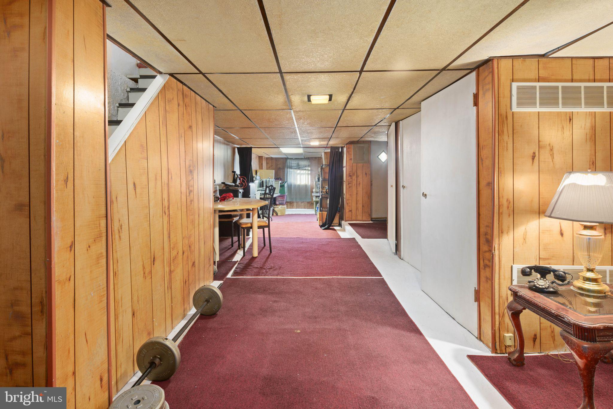 7818 Lennox Road Upper Darby, PA 19082 - Photo 23 of 28 a view of a hallway with wooden walls and stairs