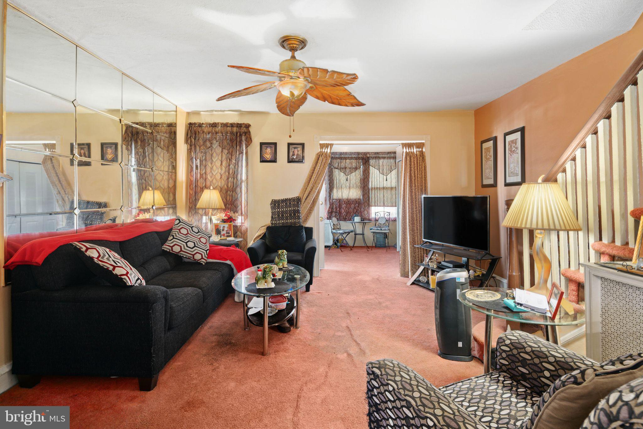 7818 Lennox Road Upper Darby, PA 19082 - Photo 7 of 28 a living room with furniture a flat screen tv and a large window