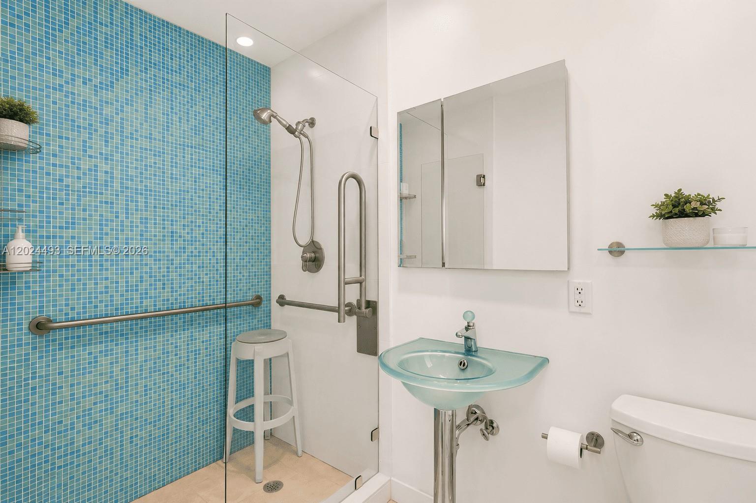 1995 Ixora Road North Miami, FL 33181 - Photo 5 of 23 a bathroom with a sink a toilet and shower
