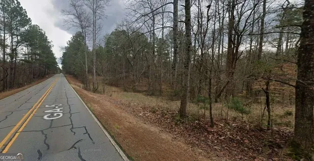 a view of a pathway with a wrought fence