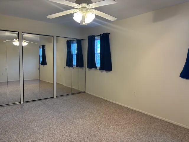 a view of an empty room with a fan