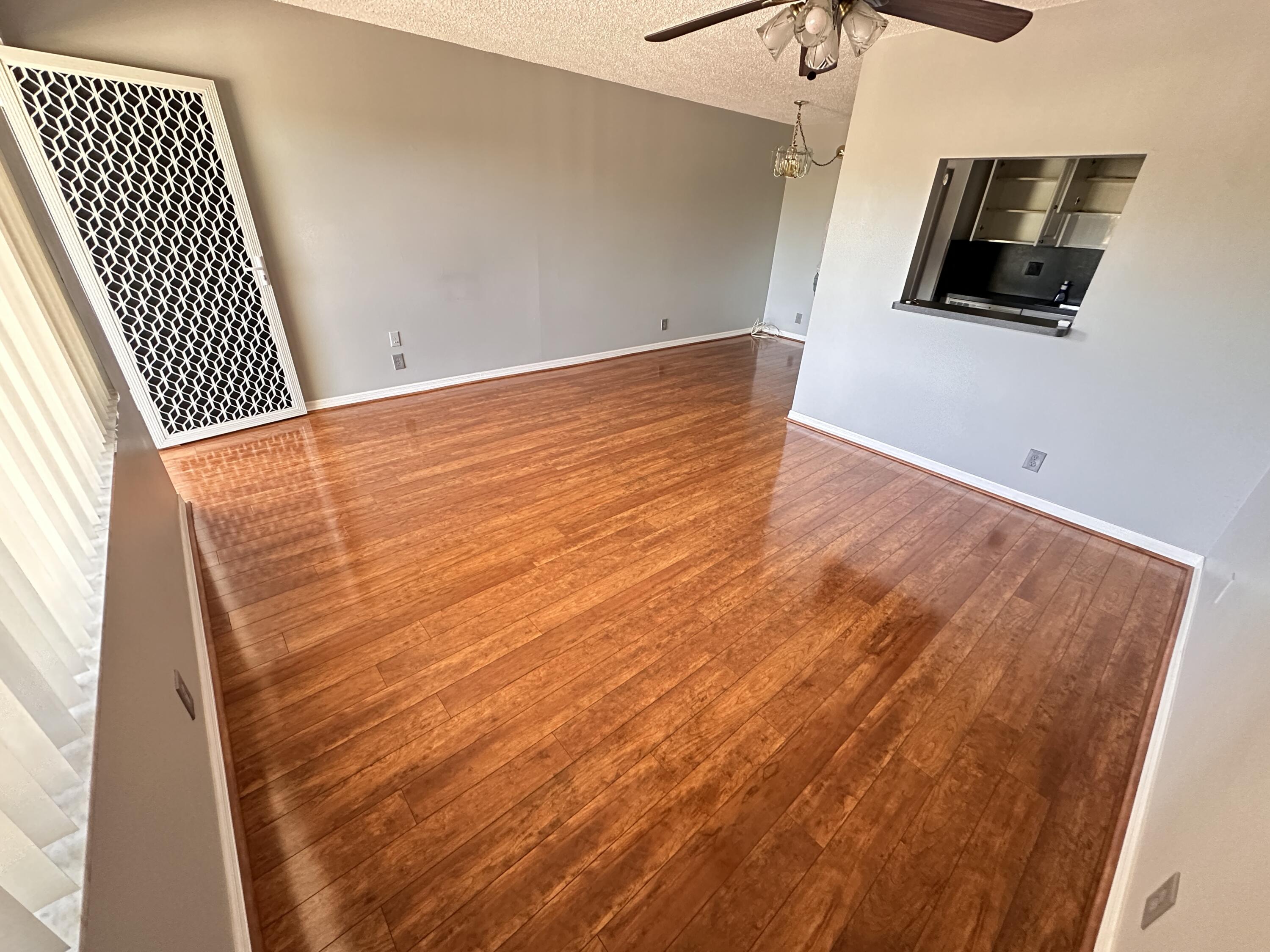 100 Village Green Circle East, Unit 306 Palm Springs, FL 33461 - Photo 2 of 9 a view of room with wooden floor
