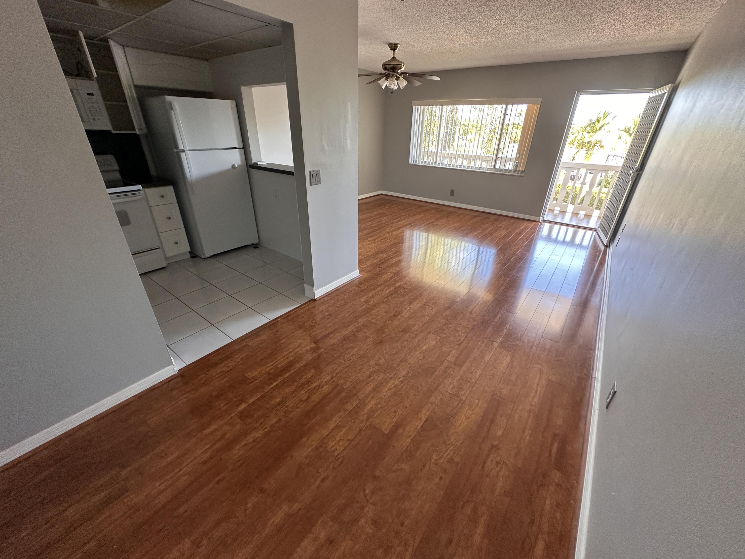 100 Village Green Circle East, Unit 306 Palm Springs, FL 33461 - Photo 3 of 9 a view of an entryway with wooden floor