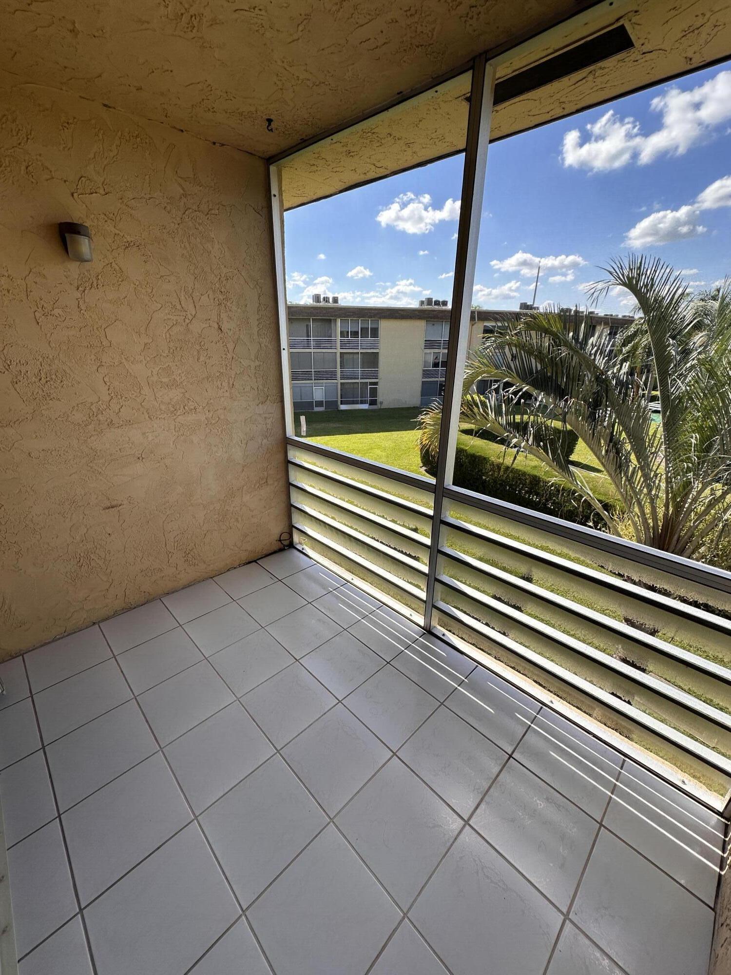 100 Village Green Circle East, Unit 306 Palm Springs, FL 33461 - Photo 7 of 9 a view of a balcony