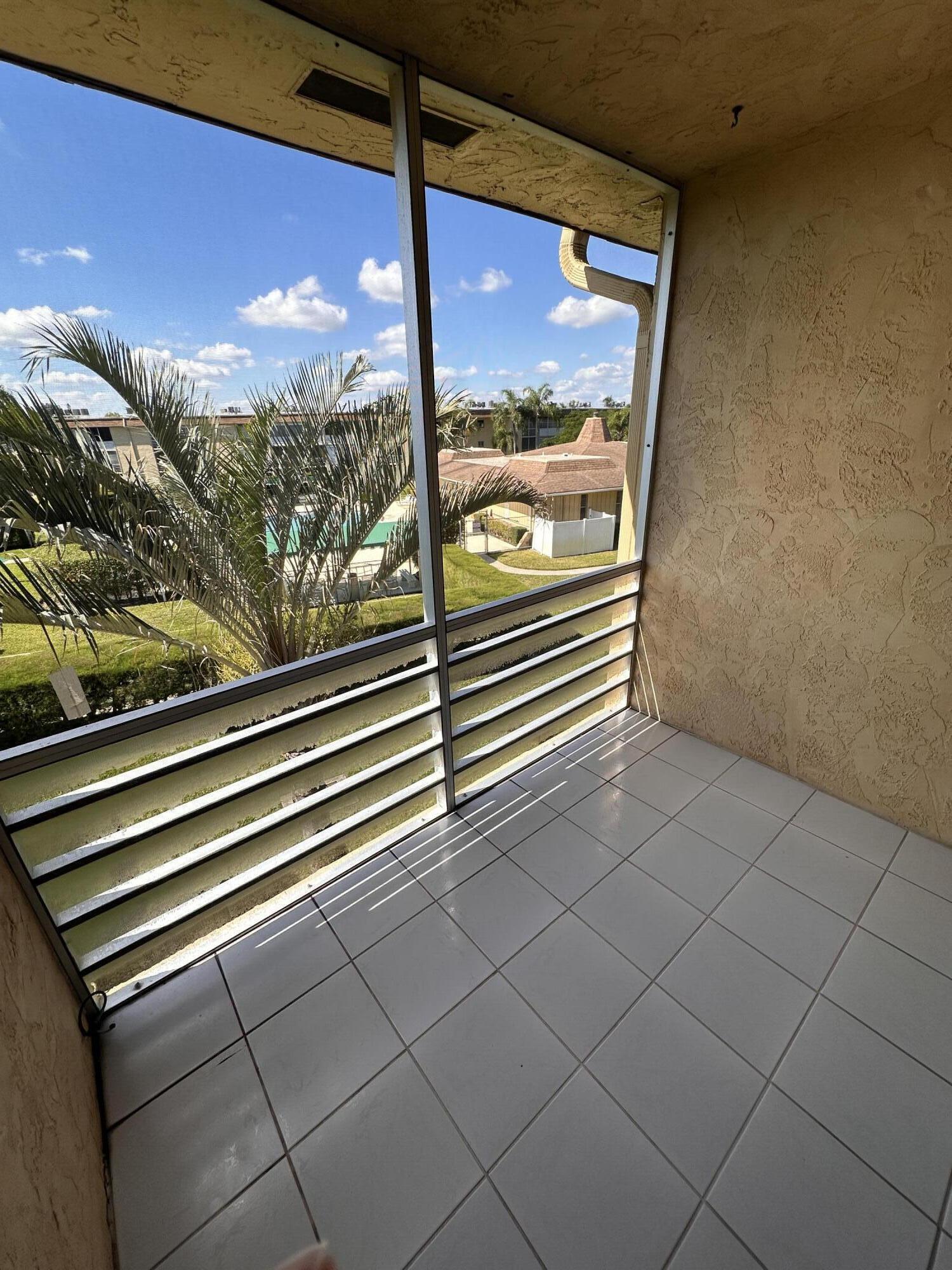 100 Village Green Circle East, Unit 306 Palm Springs, FL 33461 - Photo 8 of 9 a view of a building from a window