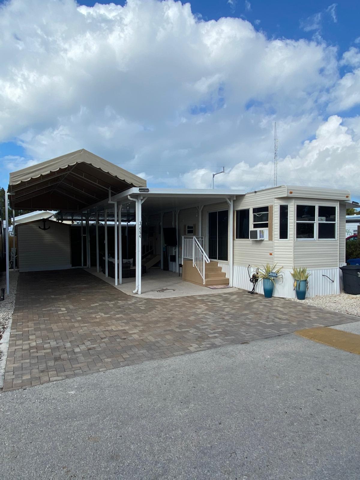 325 Calusa Street, Unit 454 Key Largo, FL 33037 - Photo 1 of 23 a couple of table and chairs in front of house