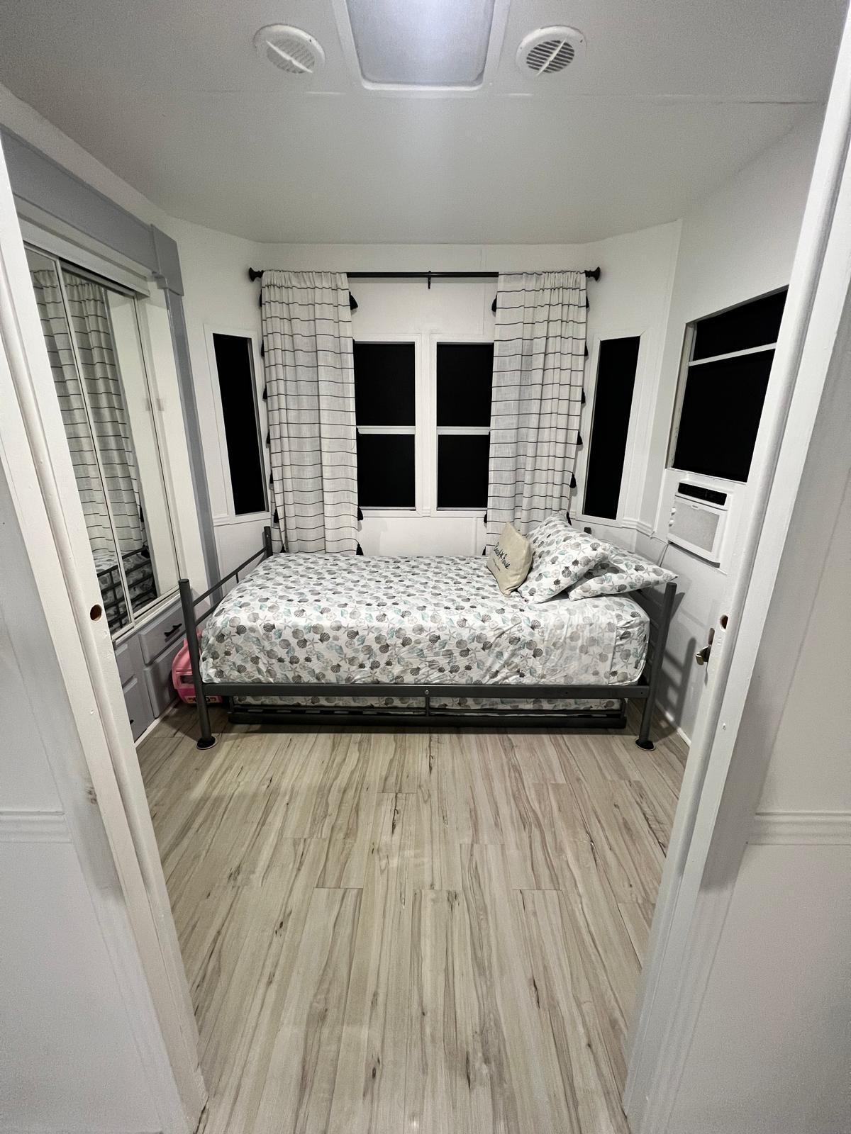 325 Calusa Street, Unit 454 Key Largo, FL 33037 - Photo 13 of 23 a bedroom with a bed wooden floor and flat screen tv