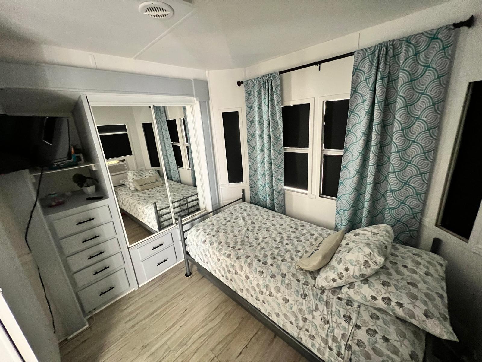 325 Calusa Street, Unit 454 Key Largo, FL 33037 - Photo 14 of 23 a bedroom with a bed and a flat tv screen on dresser