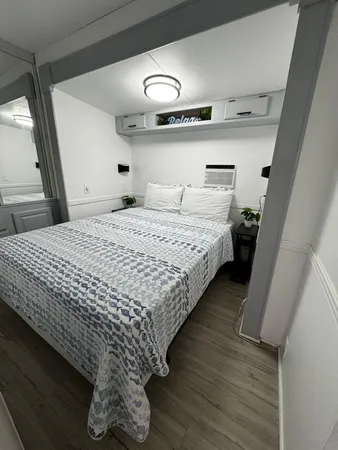 a bedroom with bed and window