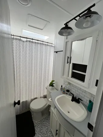 a bathroom with a sink toilet and shower