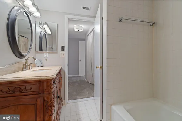 a bathroom with a granite countertop toilet a sink and a mirror