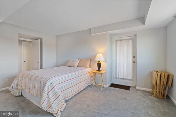 a bedroom with a bed and dresser