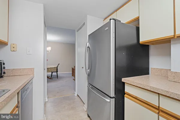 a spacious bedroom with a bed table and a flat screen tv