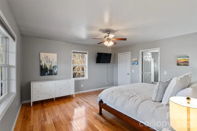 a spacious bedroom with a bed and a chandelier