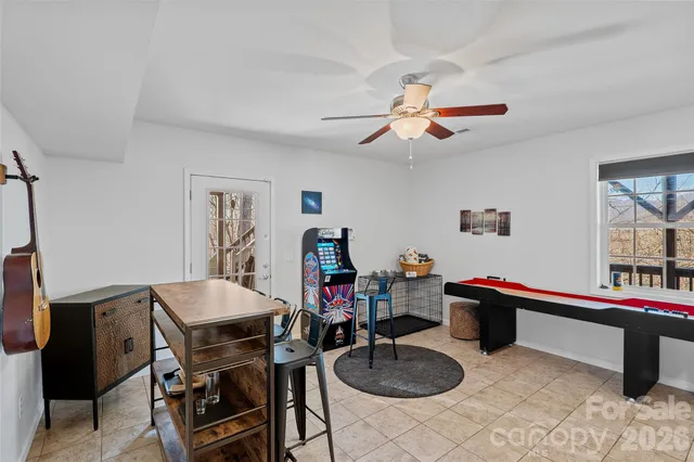 a living room with furniture a flat screen tv and a table