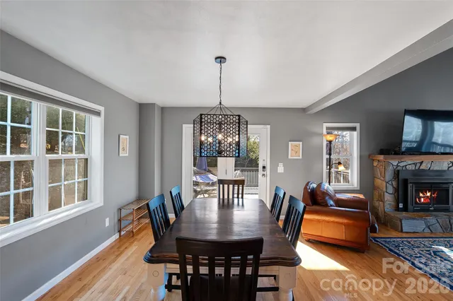 a dining room with furniture a chandelier and wooden floor