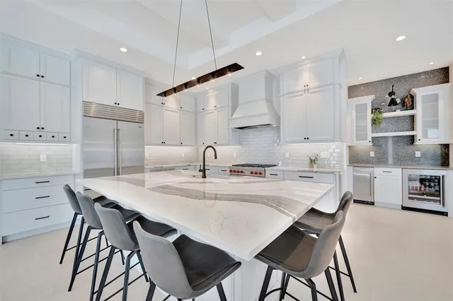 a kitchen with stainless steel appliances kitchen island granite countertop a sink and cabinets