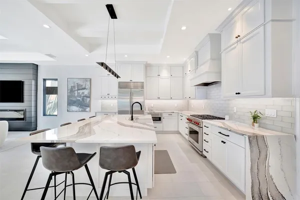 a kitchen with stainless steel appliances kitchen island granite countertop a sink and cabinets