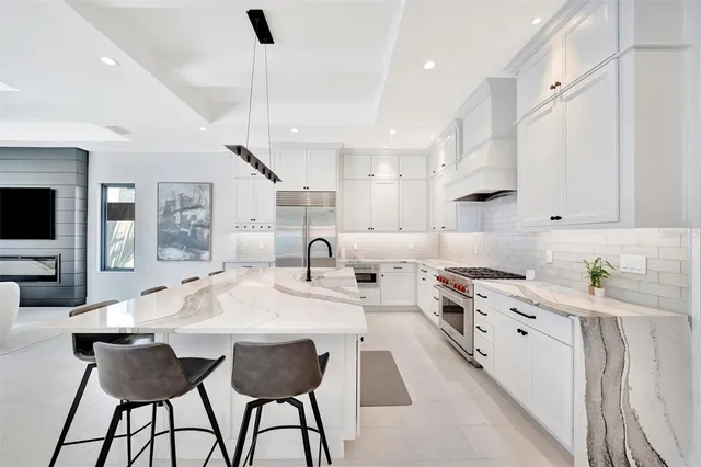 a kitchen with stainless steel appliances kitchen island granite countertop a sink and cabinets
