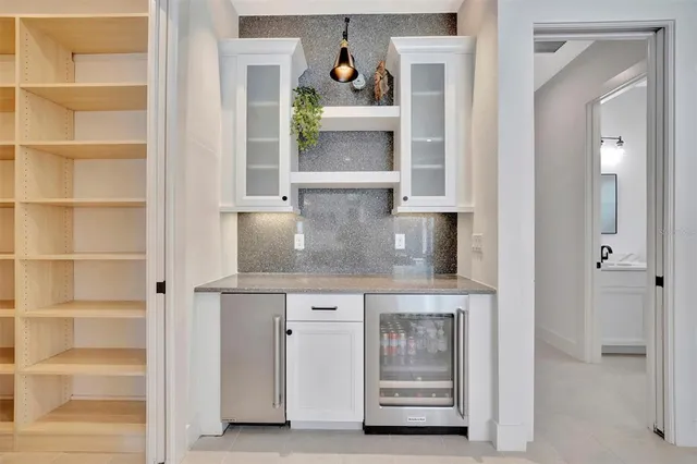 a kitchen with a stove a sink a dining table and chairs
