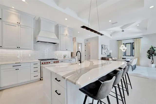 a living room with couches a coffee table and chairs with outer view