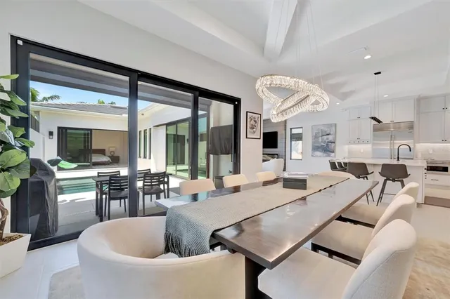 a view of house with backyard and outdoor seating