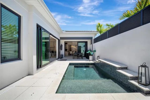 a en suite bathroom with a granite countertop sink a mirror and shower