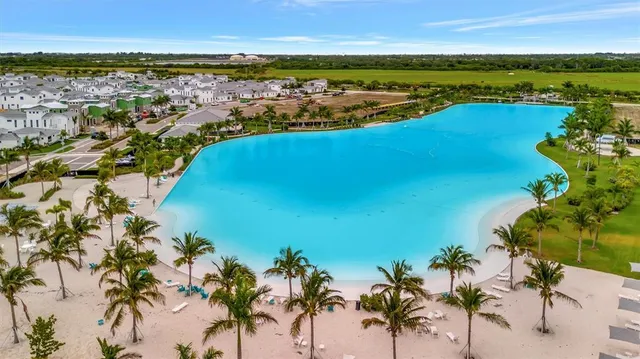a view of a hallway with kitchen view and living room