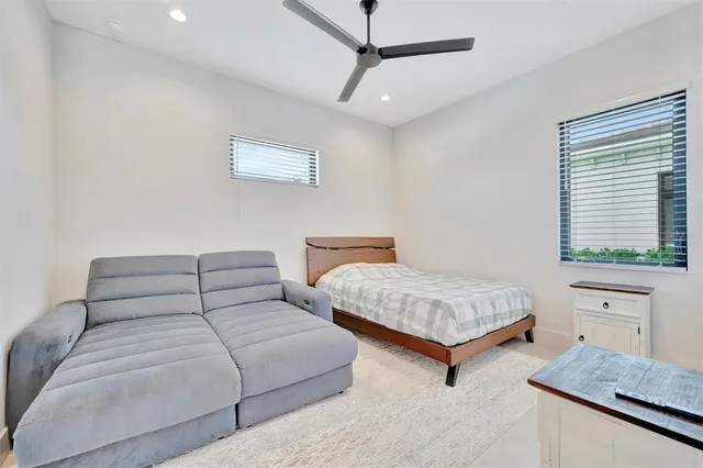 an aerial view of a swimming pool with lawn chairs