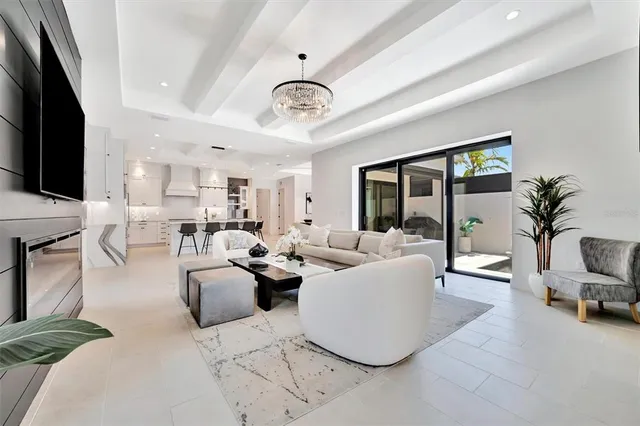 a living room with furniture kitchen view and a flat screen tv
