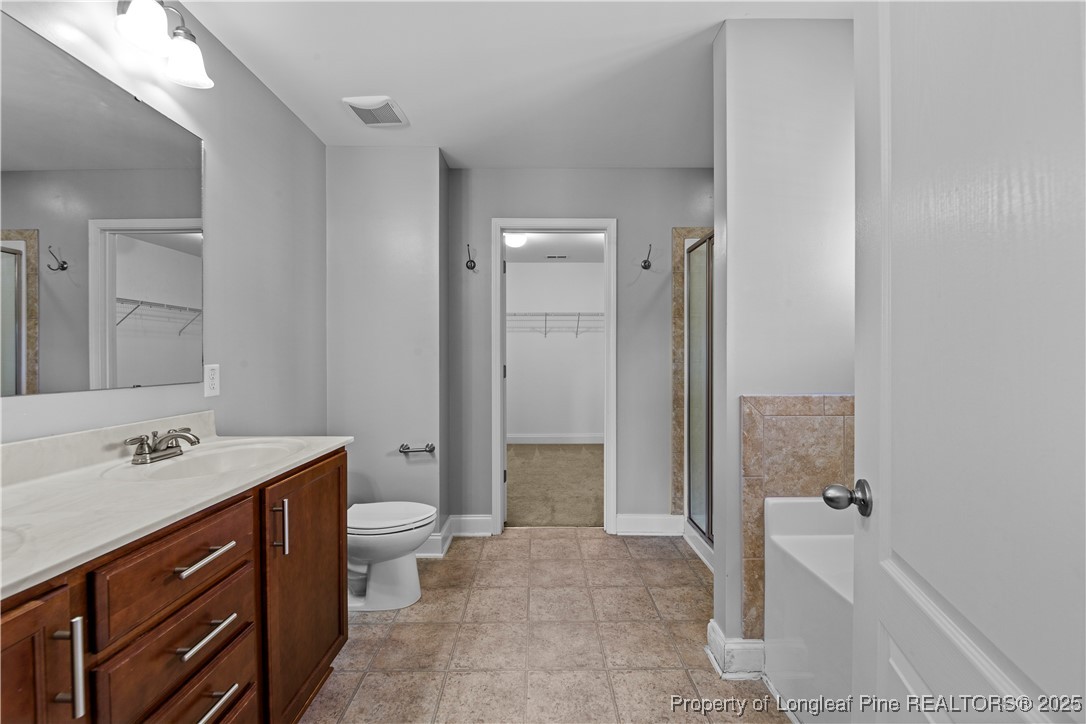 178 Tun Tavern Drive Cameron, NC 28326 - Photo 17 of 30 a bathroom with a sink a toilet and shower