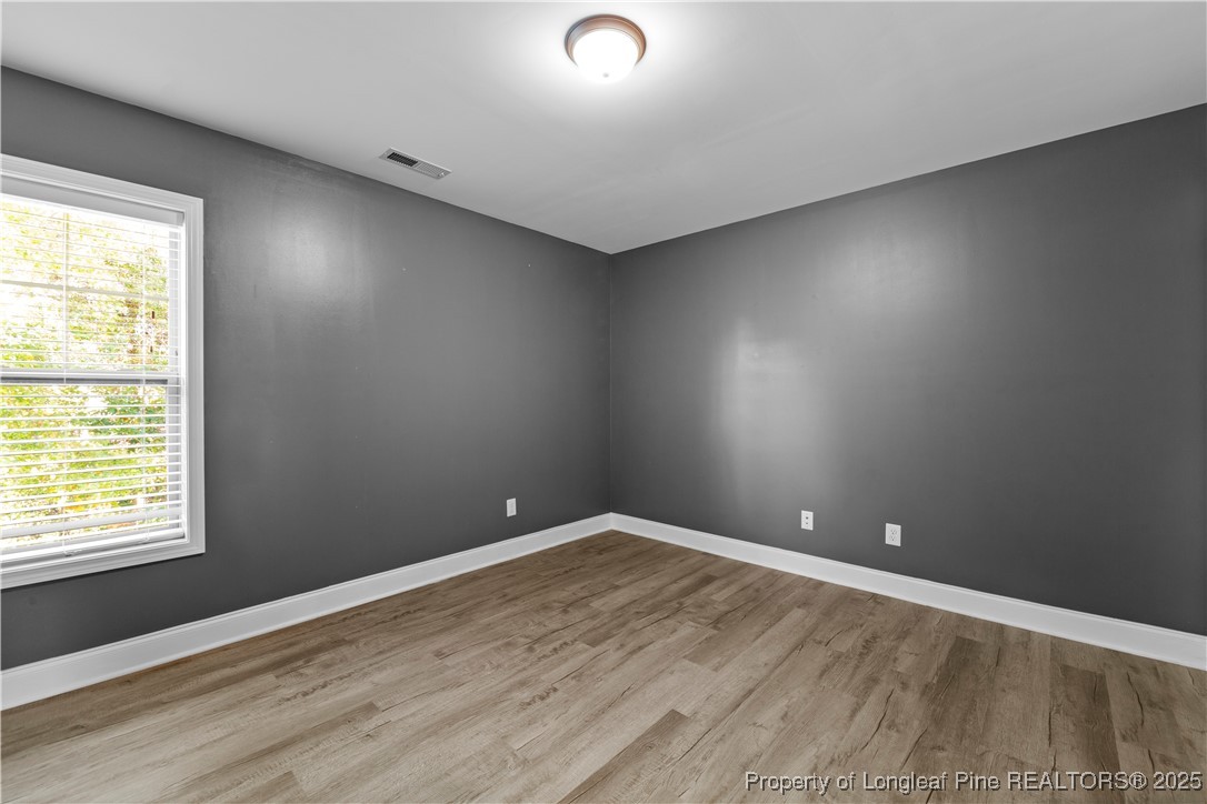 178 Tun Tavern Drive Cameron, NC 28326 - Photo 19 of 30 an empty room with wooden floor and windows
