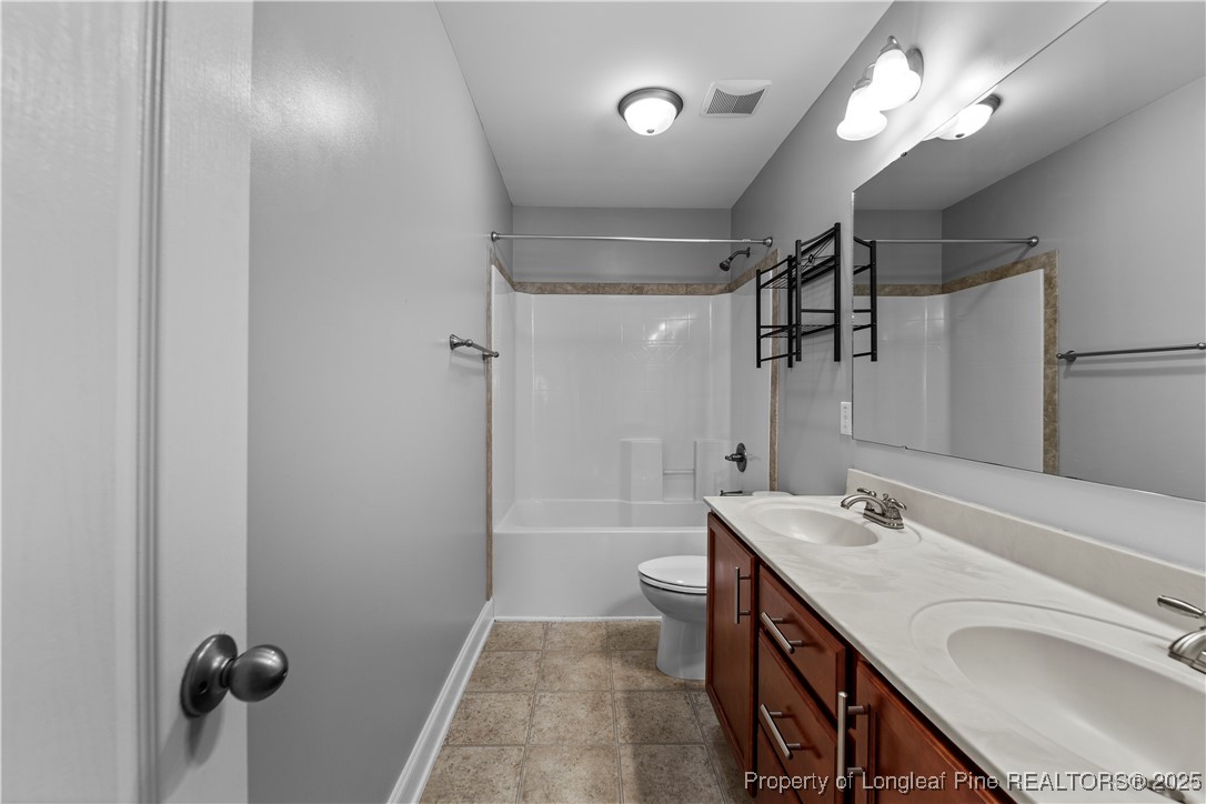 178 Tun Tavern Drive Cameron, NC 28326 - Photo 21 of 30 a bathroom with a granite countertop sink a mirror and shower