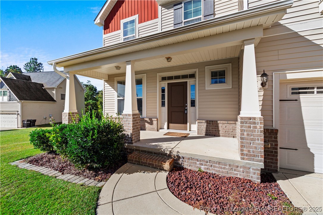 178 Tun Tavern Drive Cameron, NC 28326 - Photo 3 of 30 front view of a house with a chairs and table in a patio