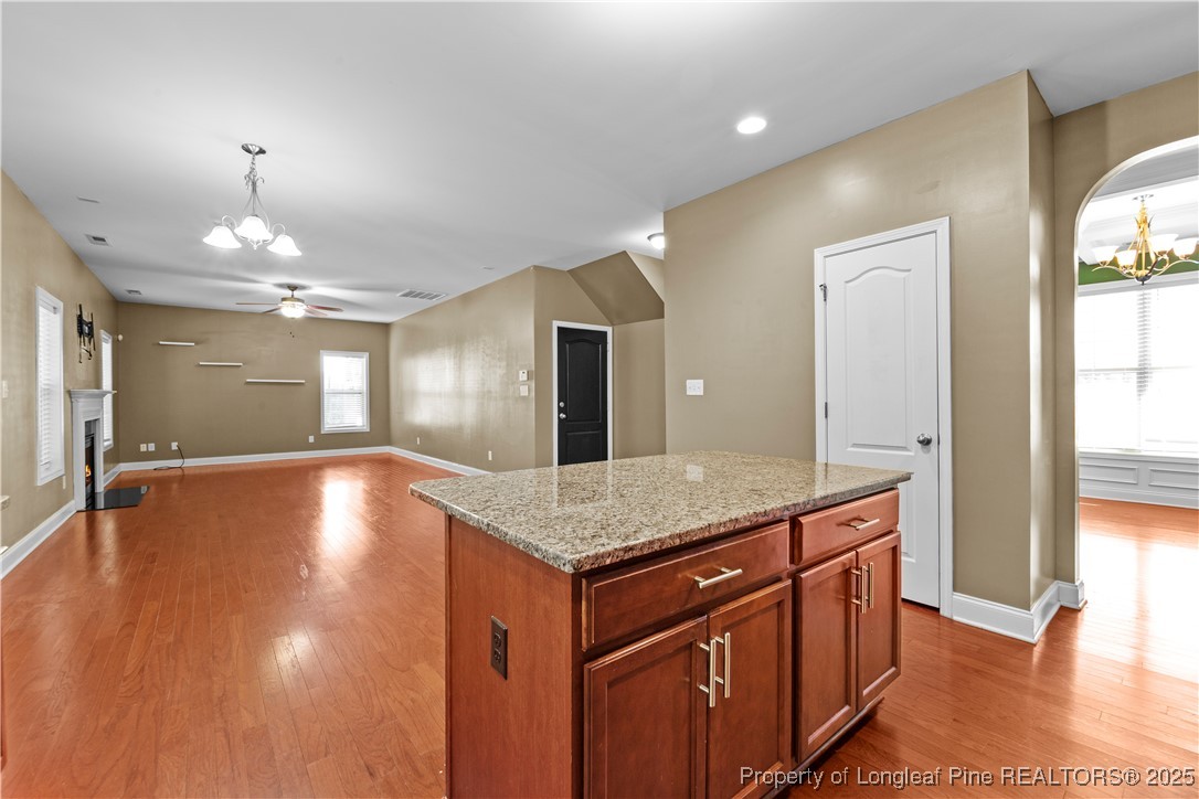 178 Tun Tavern Drive Cameron, NC 28326 - Photo 7 of 30 a view of a kitchen island a chandelier and wooden floor
