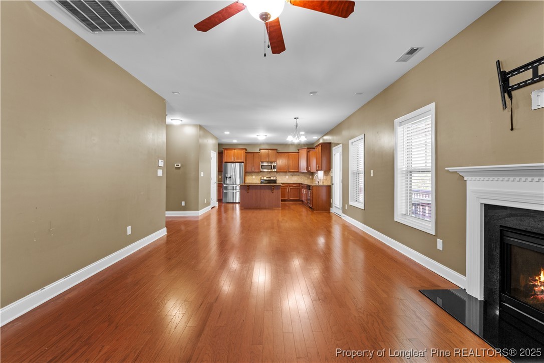 178 Tun Tavern Drive Cameron, NC 28326 - Photo 8 of 30 a view of livingroom with hardwood floor and a fireplace