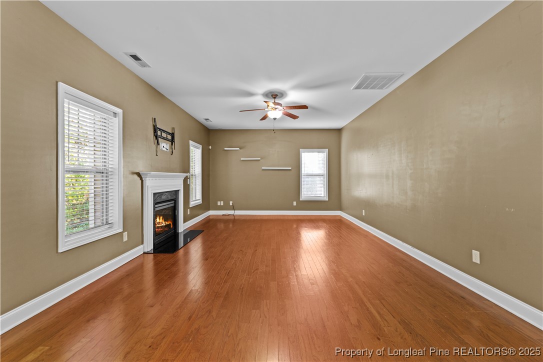178 Tun Tavern Drive Cameron, NC 28326 - Photo 9 of 30 a view of empty room with wooden floor and fireplace