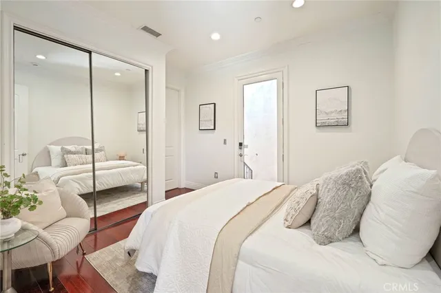 a bedroom with a bed and a large mirror