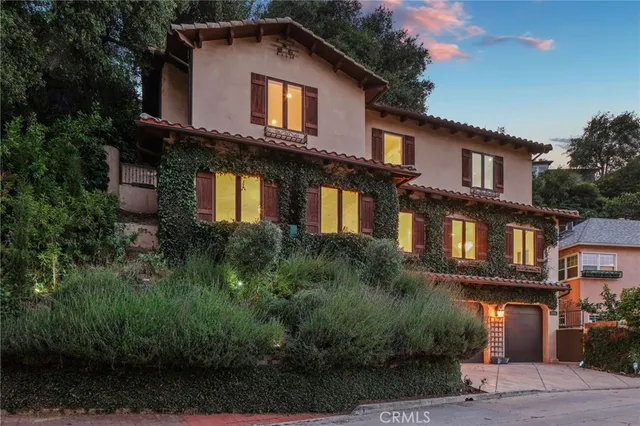 a front view of a house with a yard and balcony