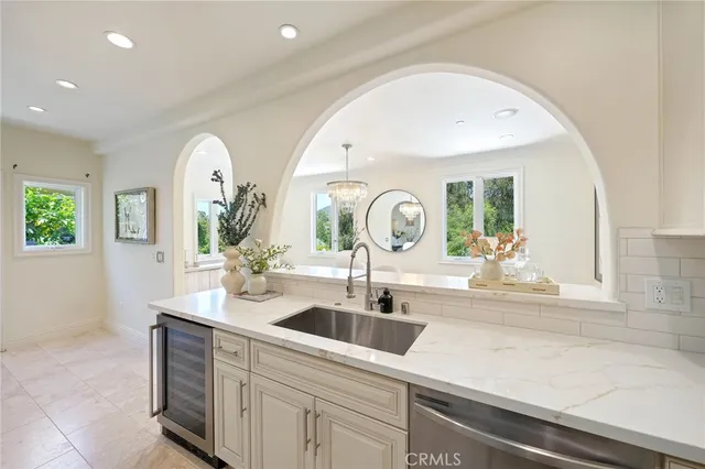 a kitchen with stainless steel appliances a sink and cabinets