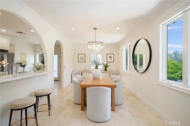 a dining room with furniture and a large window