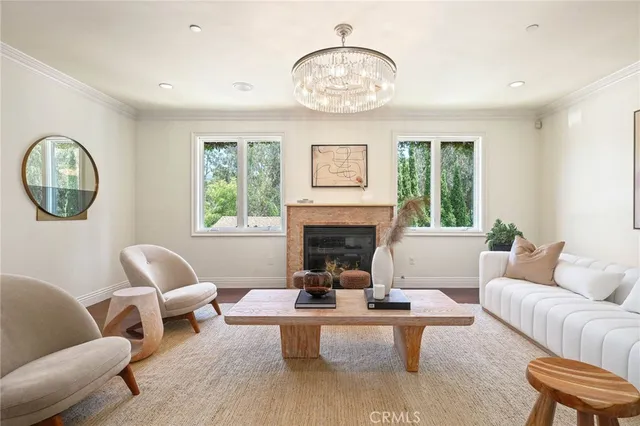 a living room with furniture a fireplace and a large window