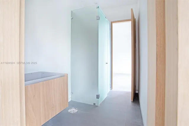 a view of an apartment with a table and chairs and potted plants